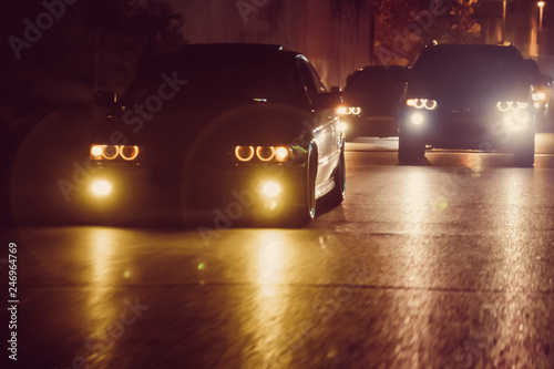 Night view of the cars. Road in the city at the night with yellow and red electrical light for cars during they are coming home. The cars compete at night. Only the lights of night carriages.