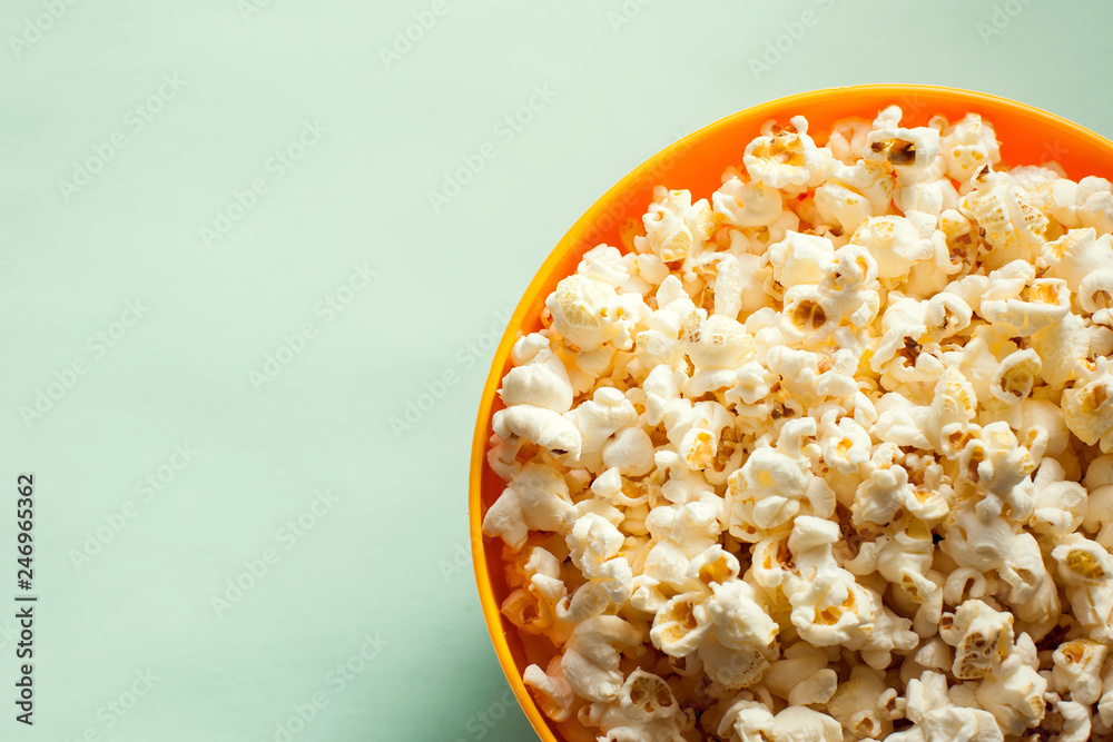 An orange bowl with popcorn isolated An orange bowl with popcorn isolated