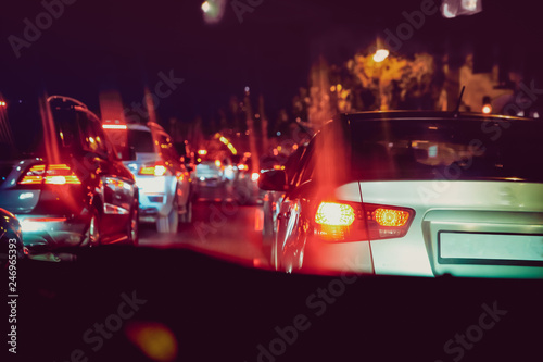 Cars in the night traffic jam . Looking behind the cars. Cars are red, yellow night light. Evening traffic jam in Baku on one of streets in the downtown
