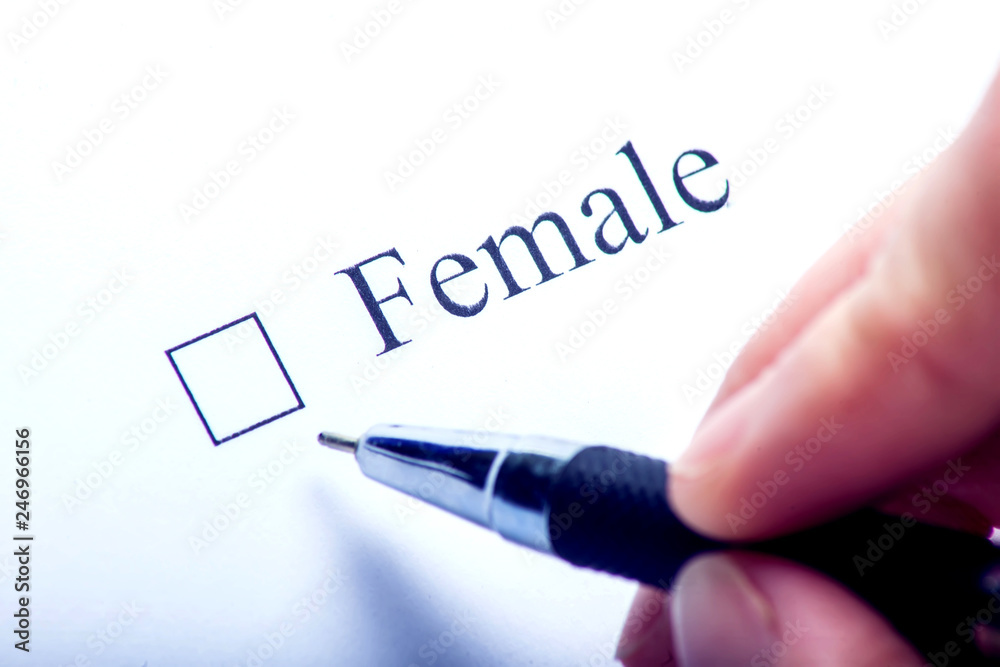 Female - checkbox with a cross on white paper with pen. Checklist concept. Female - checkbox with a cross on white paper with pen. Checklist concept.