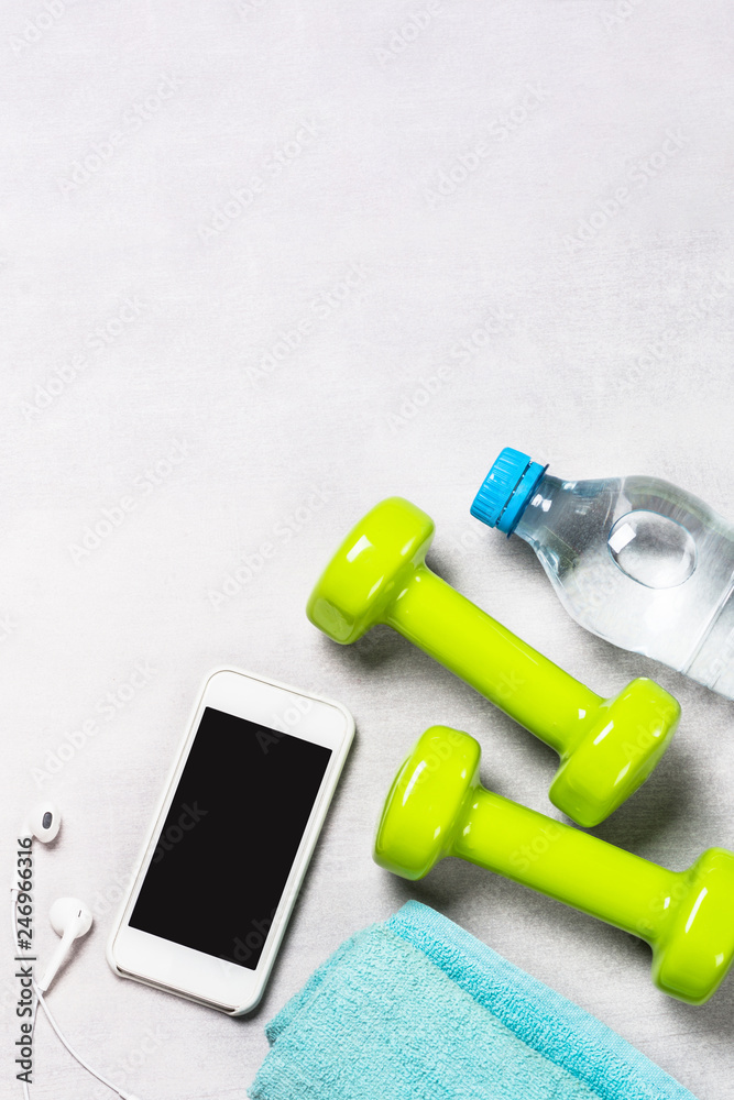 Dumbbells, measuring tape, water and apple top view. Dumbbells, measuring tape, water and apple top view.