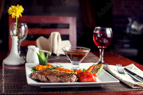 Beef steak with grilled vegetables served on white plate. Food concept