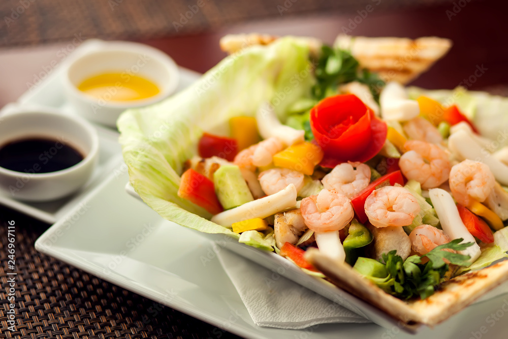 Sea food salad with sauces on white plate. Food and restaurant concept Sea food salad with sauces on white plate. Food and restaurant concept