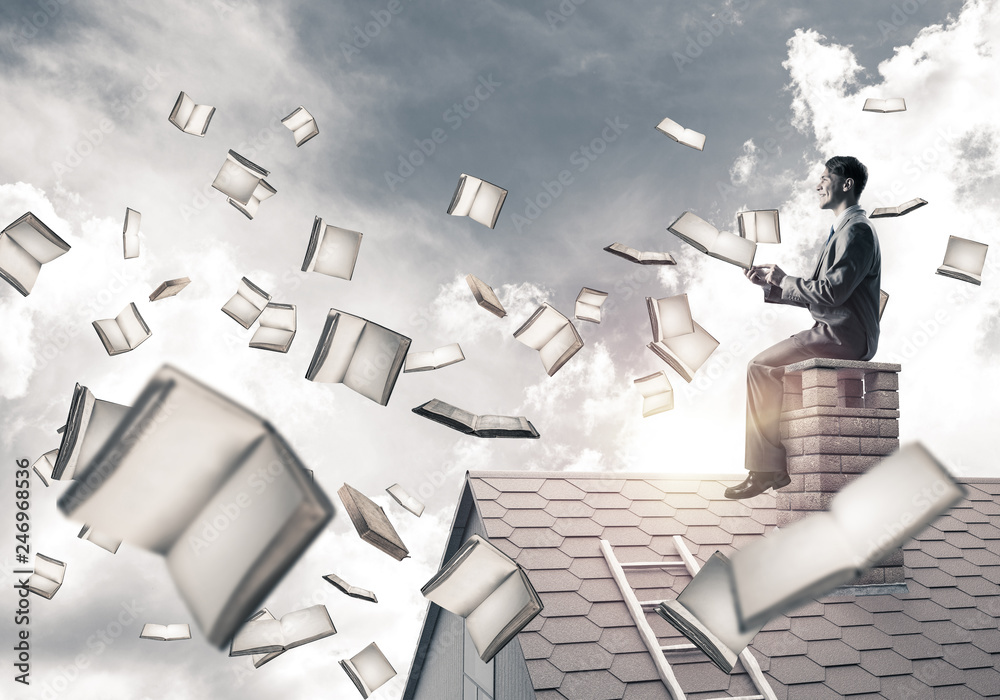 Man using smartphone and many books flying in air Man using smartphone and many books flying in air