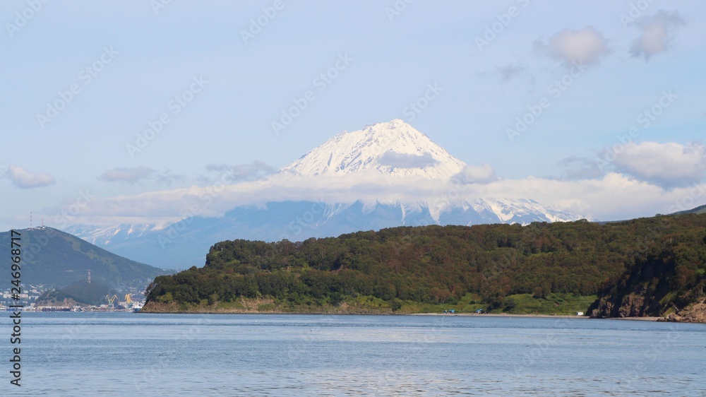 Koryaksky volcano rises above the coastline of the Kamchatka Peninsula. Koryaksky or Koryakskaya Sopka is an active volcano on the Kamchatka Peninsula in the Russian Far East. Koryaksky volcano rises above the coastline of the Kamchatka Peninsula. Koryaksky or Koryakskaya Sopka is an active volcano on the Kamchatka Peninsula in the Russian Far East.
