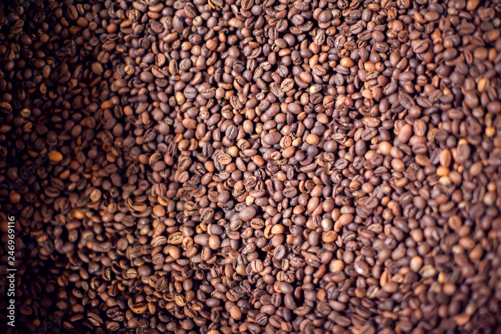 Roasted brown coffee beans pattern, background, top view texture. Organic food concept