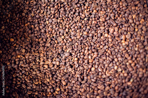 Roasted brown coffee beans pattern, background, top view texture. Organic food concept