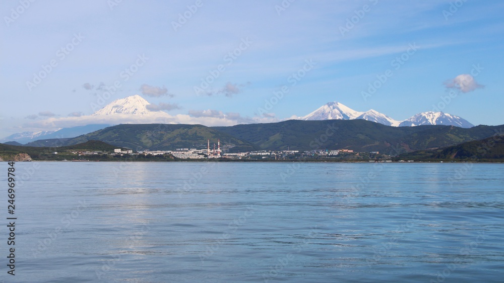 Avachinsky and Koryaksky volcanoes towers over the city of Petropavlovsk-Kamchatsky on the Kamchatka Peninsula, Russia.