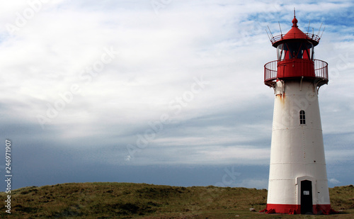 Beautiful traditional lighthous at the island sylt germany  guiding the ships through the night at the north sea