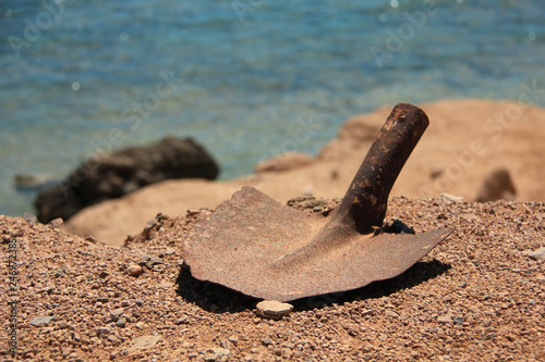 Old rusty shovel on the beach photo