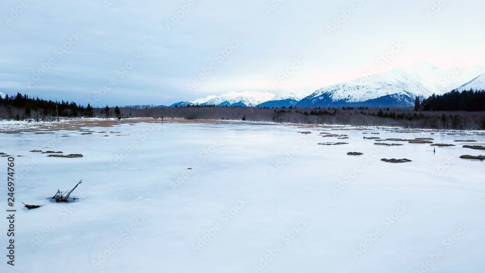 Drone flying over frozen marsh in Alaska during the evening Drone flying over frozen marsh in Alaska during the evening