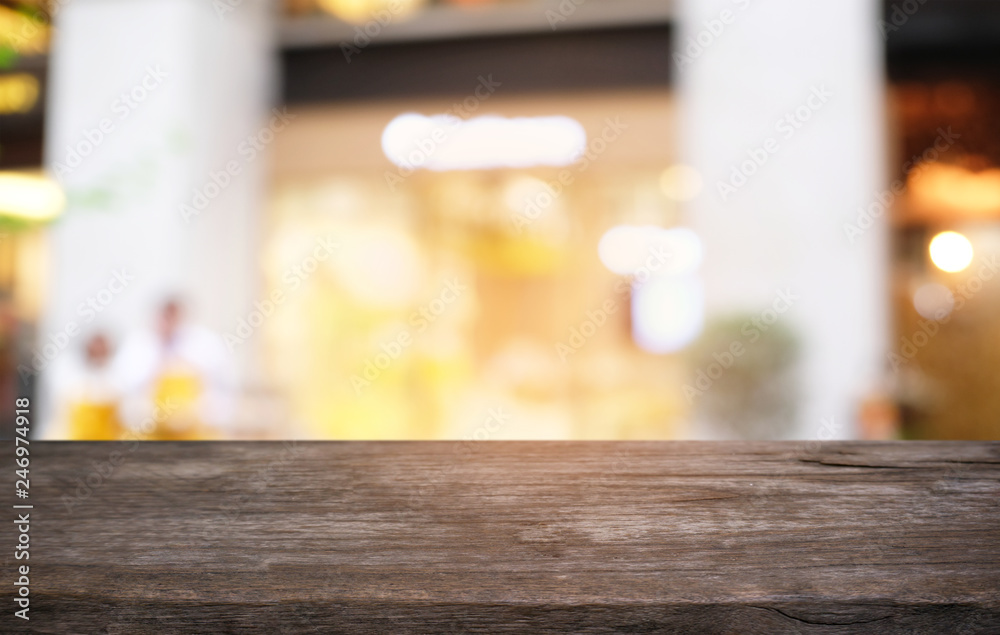 Empty dark wooden table in front of abstract blurred bokeh background of restaurant . can be used for display or montage your products.Mock up for space. Empty dark wooden table in front of abstract blurred bokeh background of restaurant . can be used for display or montage your products.Mock up for space.
