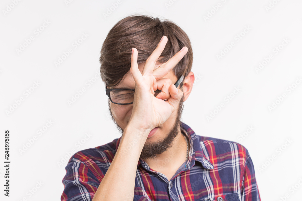 Young creative man holding fingers near eyes like glasses. Fun concept, Young creative man holding fingers near eyes like glasses. Fun concept,