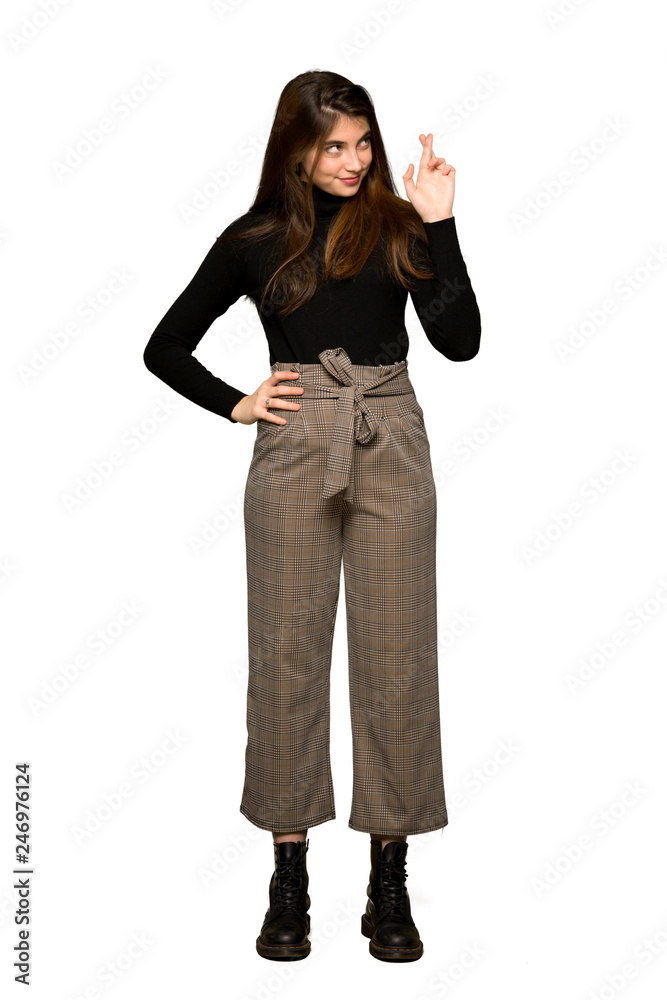 Full-length shot of Pretty girl with fingers crossing and wishing the best on isolated white background Full-length shot of Pretty girl with fingers crossing and wishing the best on isolated white background