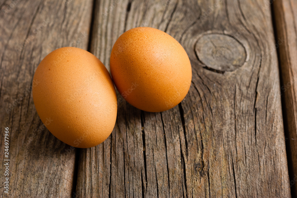 two eggs on weathered wooden table two eggs on weathered wooden table
