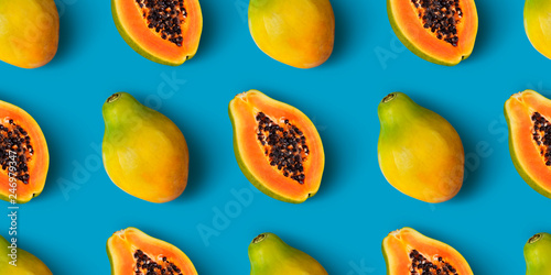 Papaya fruit seamless pattern on blue color background photo
