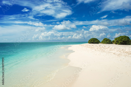 coastline on the coral Atoll. Paradise tropical island, white sand and clear water. Landscape