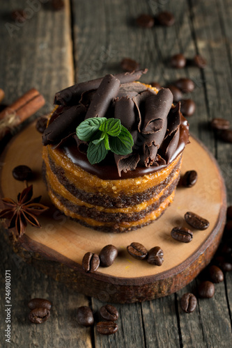 Chocolate cakes on black slatter board with mint, coffee beans on dark background, closeup photo. Fresh, tasty dessert food concept.  photo