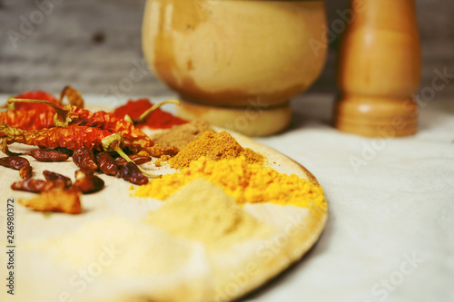 Mix of indian spices in a wooden table photo