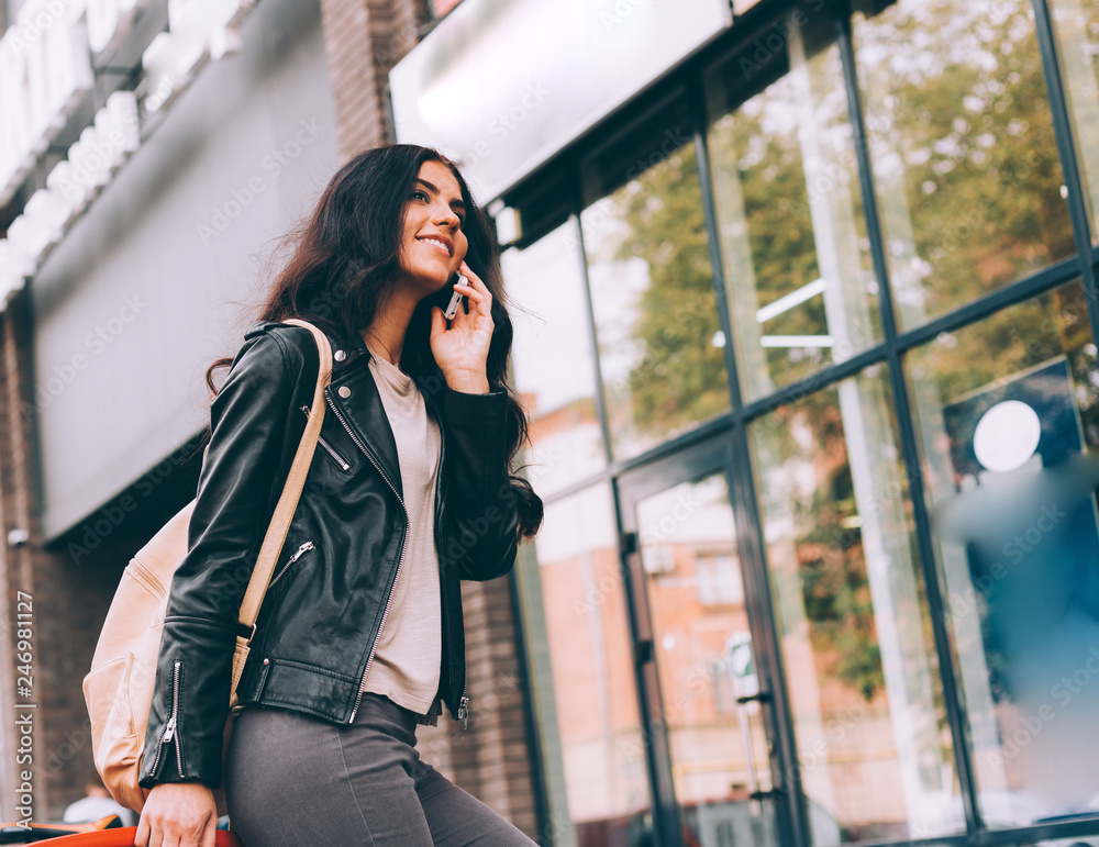 Young pretty latin woman walking near shops in city centre Young pretty latin woman walking near shops in city centre