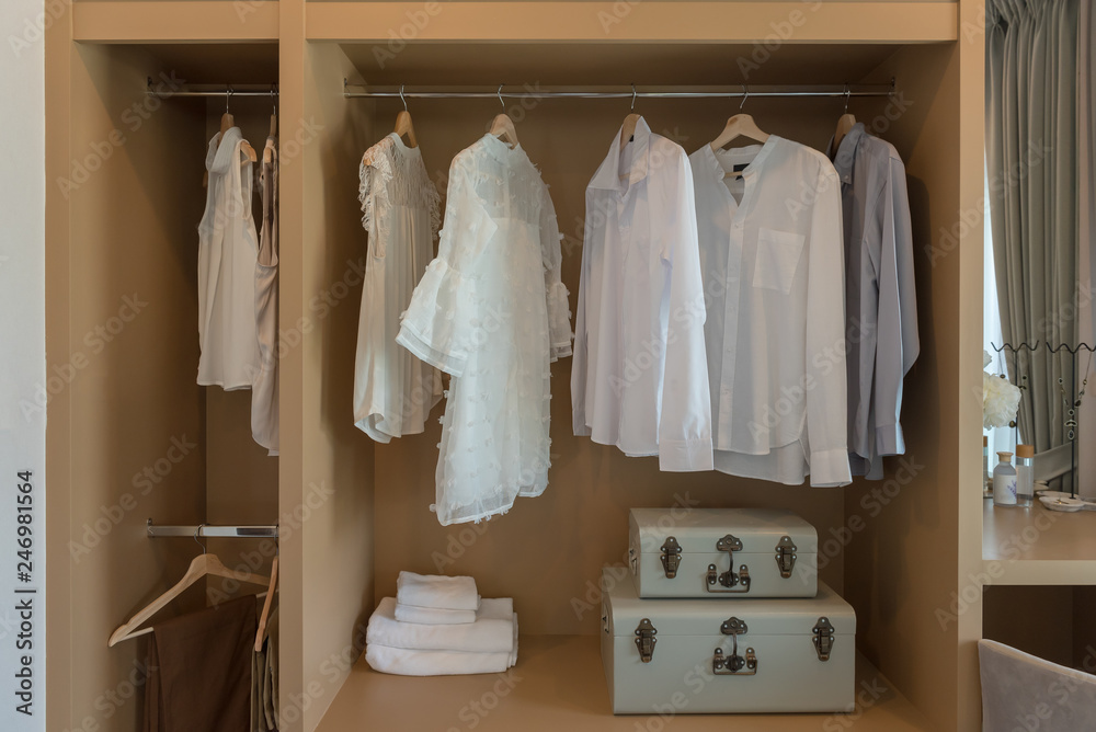modern closet with clothes hanging modern closet with clothes hanging
