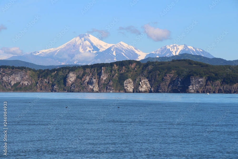 View of Tri Brata with Avachinsky and Kozelsky volcanoes in the background. Tri Brata (Russian: Три Брата; literally: 