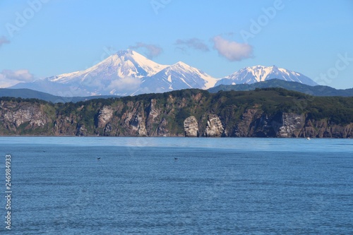 View of Tri Brata with Avachinsky and Kozelsky volcanoes in the background. Tri Brata (Russian: Три Брата; literally: "three brothers") is a set of three rocks at the entrance to the Avacha Bay.