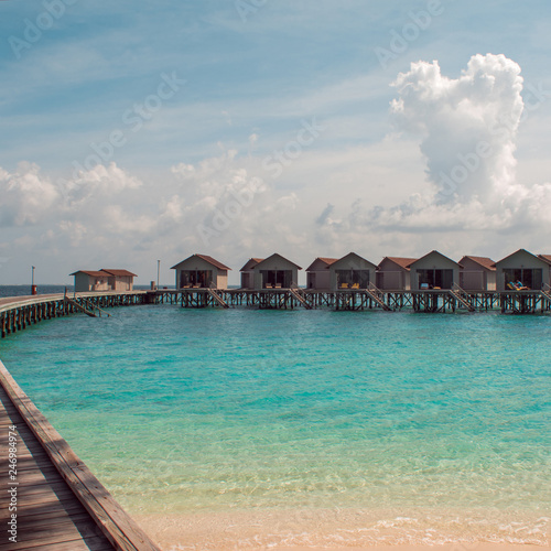 Love on Paradise island  concept. Bungalow on stilts in the water  amazing tropical nature. Maldives resort