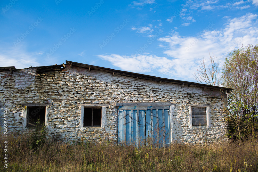 abandoned farm among the tall grass, under a cloudy sky abandoned farm among the tall grass, under a cloudy sky