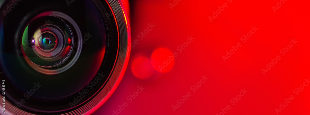Banner. The camera lens and red background. Stock Photo | Adobe Stock