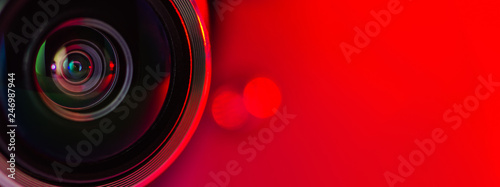 Banner. The camera lens and  red background.