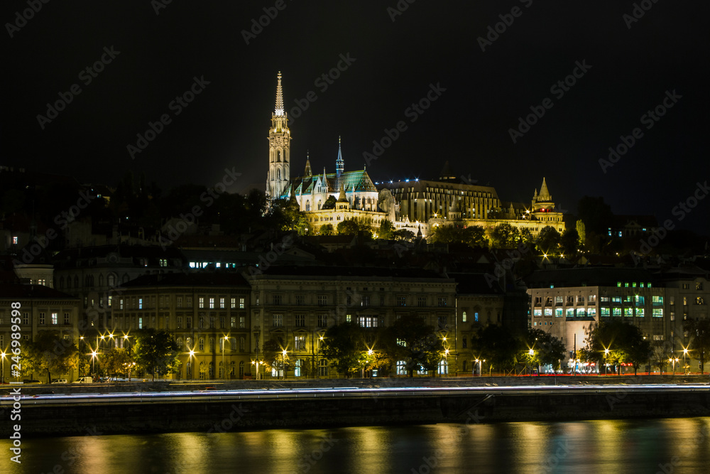 Night view of the Fisherman's Bastion and Matthias Church on the banks of the Danube river in Budapest. Hungary