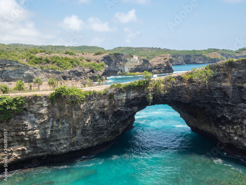 Amazing rock coastline. Stone arch over the sea. Broken beach  Nusa Penida  Indonesia. October  2018