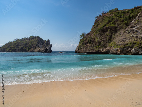 Big rocks in the ocean with white sand at Atuh beach on Nusa Penida island, Indonesia. November, 2018