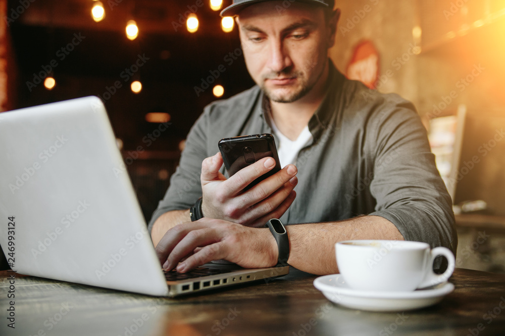 young man  working in cafe and drink black coffee