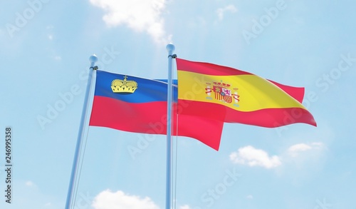 Spain and Liechtenstein, two flags waving against blue sky. 3d image