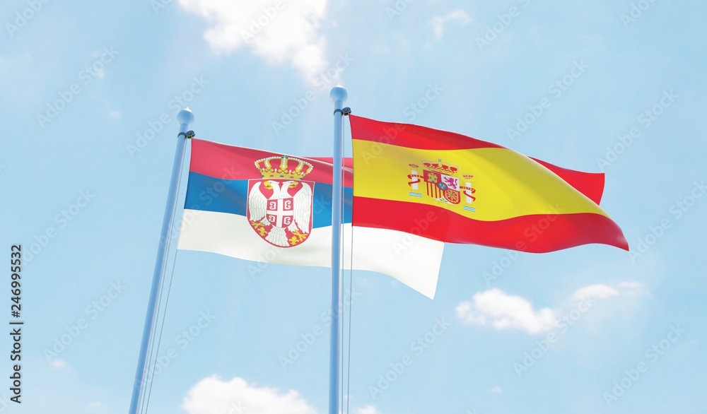 Spain and Serbia, two flags waving against blue sky. 3d image Spain and Serbia, two flags waving against blue sky. 3d image