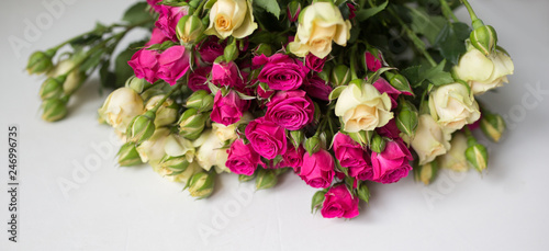 Fototapeta Naklejka Na Ścianę i Meble -  Pink and white rose bush collected in a bouquet. Beautiful floristry for weddings, holidays. Floral decoration of flowers. Panorama background.