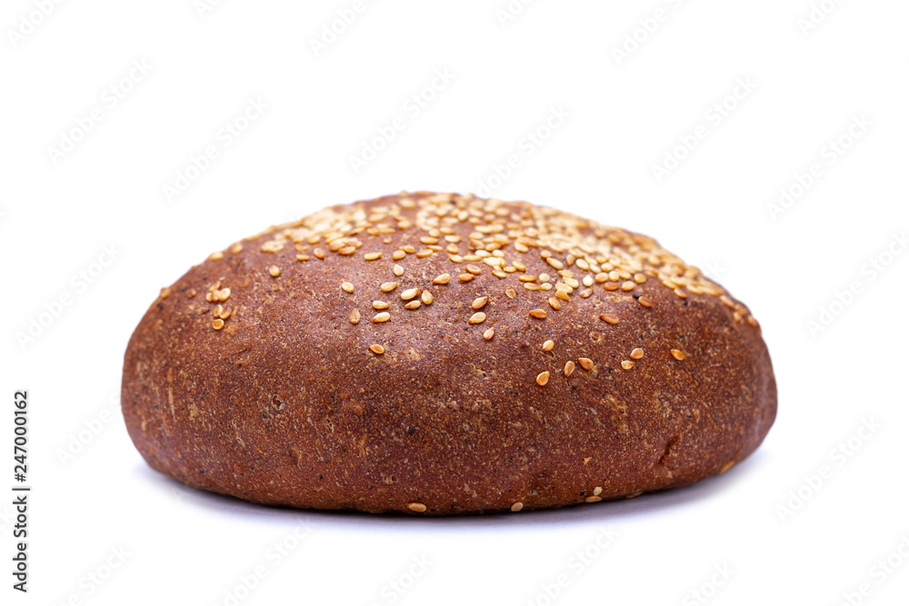 Brown freshly baked sesame bun isolated on white background. Flour products Brown freshly baked sesame bun isolated on white background. Flour products