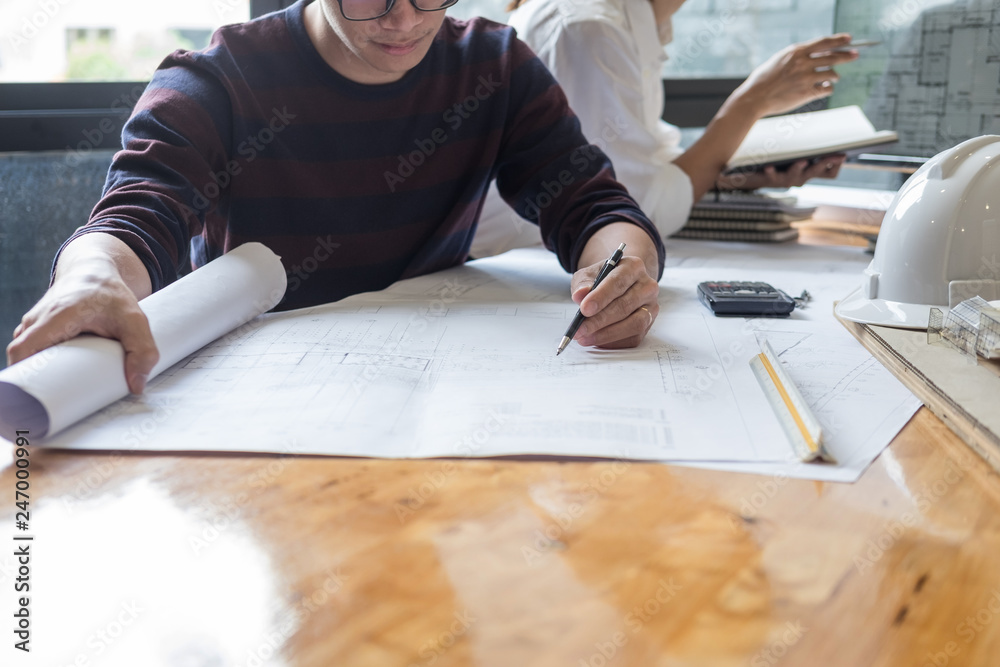 professional architects working on blueprint discussing construction plans, engineer building, business co-working teamwork concept. professional architects working on blueprint discussing construction plans, engineer building, business co-working teamwork concept.
