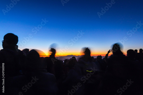 Dramatic landscape of silhouette people taking photo and waiting for the sunrise at the mountain view point.  long exposure 