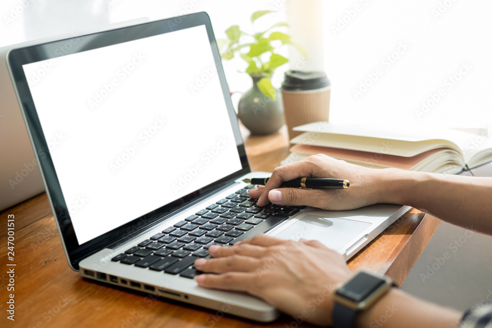 Young man sitting in office and working on digital tablet document and laptop and notebook in office. Young man sitting in office and working on digital tablet document and laptop and notebook in office.
