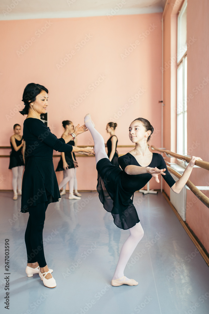 Fototapeta premium The group of beautiful teenage girls practicing ballet dance.