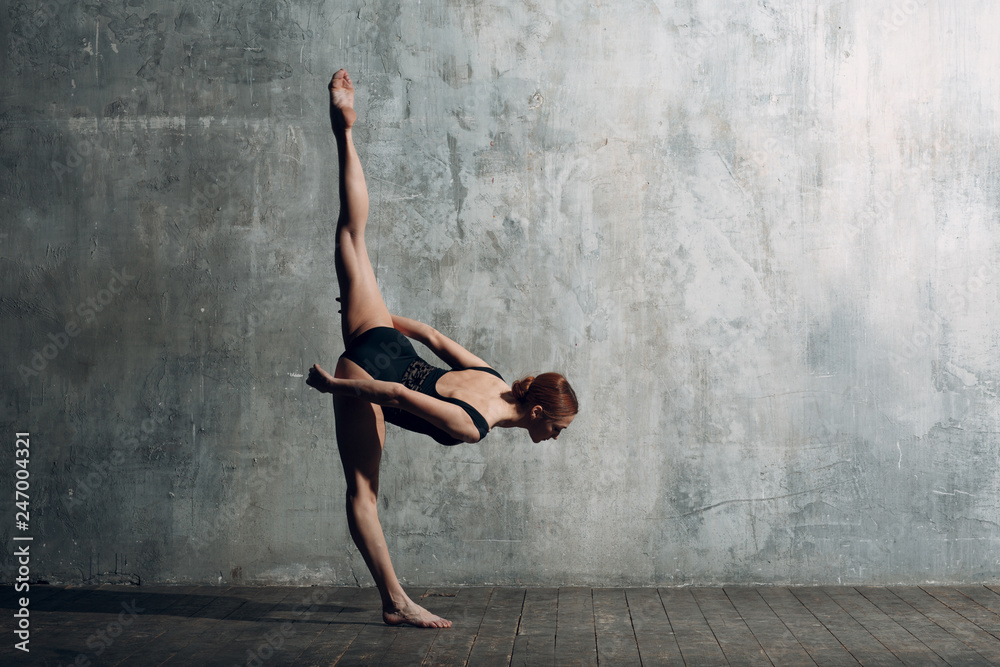 Ballerina female. Young beautiful woman ballet dancer, dressed in professional outfit, pointe shoes and black body.