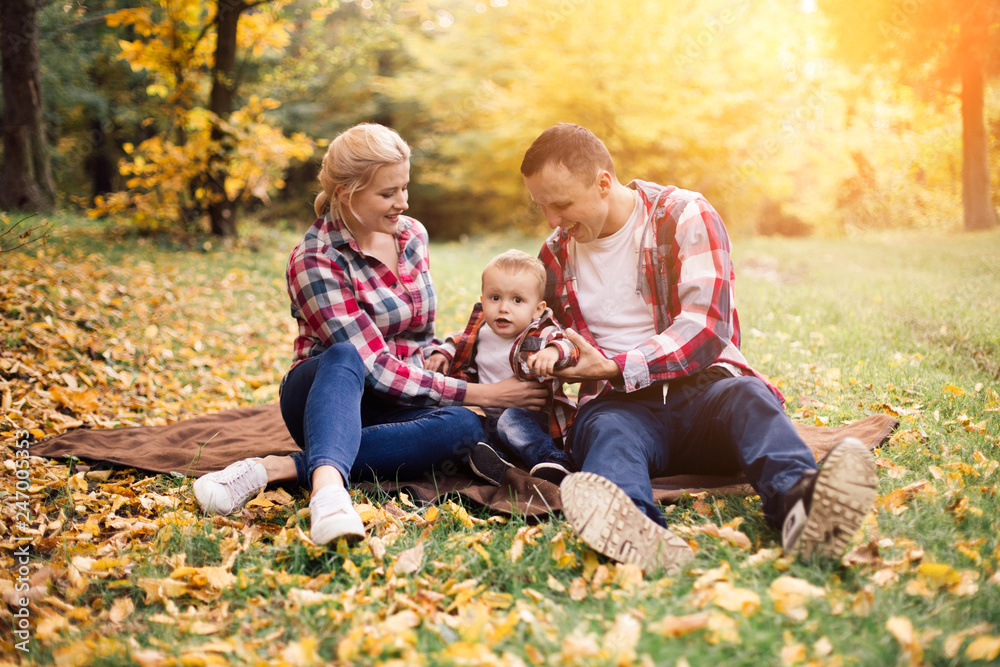 Little cute son playing with parents in forest Little cute son playing with parents in forest
