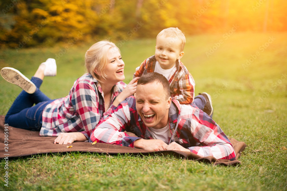 Family on weekend. Mother father and son in park Family on weekend. Mother father and son in park