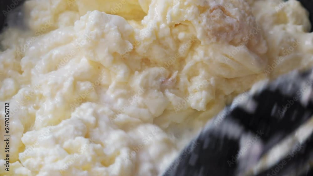 Mixing scrambled eggs on frying pan, closeup Mixing scrambled eggs on frying pan, closeup