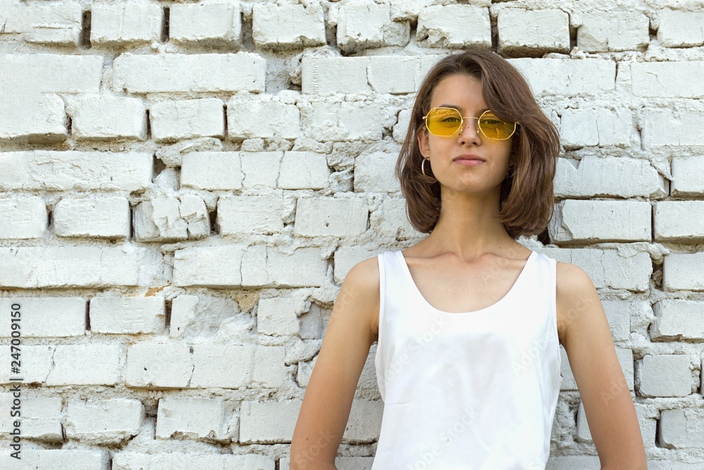 Serious Teenage girl in yellow glasses. Copy space. Serious Teenage girl in yellow glasses. Copy space.