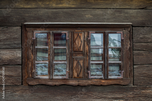 Rustic old peasant house with wooden windows