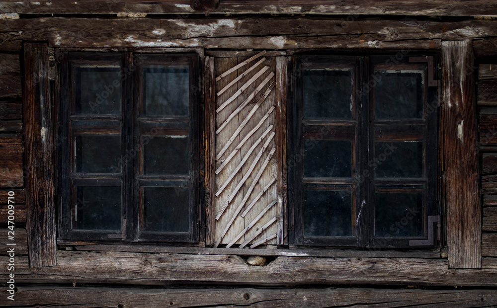 Rustic old peasant house with wooden windows Rustic old peasant house with wooden windows